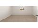 Carpeted bedroom features neutral colors, a window, and door at 8599 Secretariat Dr, Lithonia, GA 30058
