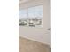 A bedroom with large windows, blinds, and neutral colored carpet at 8599 Secretariat Dr, Lithonia, GA 30058