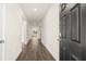New construction entryway with dark wood floors and white walls at 8599 Secretariat Dr, Lithonia, GA 30058