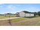 Exterior view of home with bright white siding, attached two-car garage and long driveway at 8599 Secretariat Dr, Lithonia, GA 30058