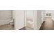 Hallway with a bathroom on the left and bedrooms straight ahead at 8599 Secretariat Dr, Lithonia, GA 30058
