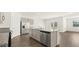 Kitchen with gray cabinets, stainless steel appliances, and a large island at 8599 Secretariat Dr, Lithonia, GA 30058
