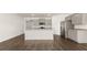 Kitchen features stainless appliances, island with granite, and gray cabinets at 8599 Secretariat Dr, Lithonia, GA 30058