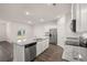 Open kitchen with granite countertops, stainless steel appliances, and white cabinets with wood-look flooring at 8599 Secretariat Dr, Lithonia, GA 30058