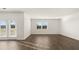 Bright living room featuring wood floors, white walls, and natural light at 8599 Secretariat Dr, Lithonia, GA 30058