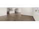 Spacious living area with hardwood floors leads to kitchen with stainless appliances and island at 8599 Secretariat Dr, Lithonia, GA 30058