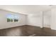 Living Room with wood floors, white walls, and large window with natural light at 8599 Secretariat Dr, Lithonia, GA 30058