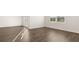 Bright living room features hardwood floors and plenty of natural light from the window at 8599 Secretariat Dr, Lithonia, GA 30058