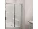 A glass-door shower stall with white tile and a built-in seat at 8599 Secretariat Dr, Lithonia, GA 30058