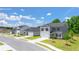 A street view of new construction homes featuring beautifully landscaped lawns and tree-lined sidewalks at 8599 Secretariat Dr, Lithonia, GA 30058