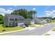 New homes with garages, paved driveways, sidewalks, and well-manicured lawns line this neighborhood street at 8599 Secretariat Dr, Lithonia, GA 30058