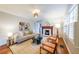 Bright living room featuring hardwood floors, fireplace, and large window at 2726 Craigie Ave, Decatur, GA 30030