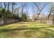 Large, level backyard featuring a shed, lush lawn, and wooden fence at 440 River Valley Rd, Atlanta, GA 30328