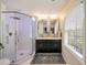 Modern bathroom featuring a glass enclosed shower with rainfall shower head and double sink vanity with marble countertop at 440 River Valley Rd, Atlanta, GA 30328