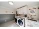 Functional laundry room featuring modern appliances, ample counter space, sink, and plenty of storage at 440 River Valley Rd, Atlanta, GA 30328