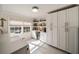 Bright office space featuring built-in shelves, cabinets, a wine fridge and natural light from the window at 440 River Valley Rd, Atlanta, GA 30328