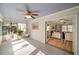 Bright sunroom with multiple windows, tile flooring and hanging swing chairs at 440 River Valley Rd, Atlanta, GA 30328