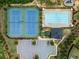 Aerial view of community pool, tennis courts, parking, and playground surrounded by green landscaping at 4779 Mock Orange Sw St, Atlanta, GA 30331