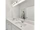 Bright bathroom with double vanity and large mirror at 4779 Mock Orange Sw St, Atlanta, GA 30331