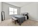 This carpeted bedroom has a large window and a bench at 4779 Mock Orange Sw St, Atlanta, GA 30331