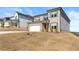 Well-kept, two-story house with brick details, and green grass; situated on a manicured lawn at 4779 Mock Orange Sw St, Atlanta, GA 30331