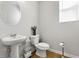 Neat half bathroom featuring a pedestal sink, decorative fixtures and white walls at 4779 Mock Orange Sw St, Atlanta, GA 30331