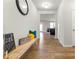 Inviting hallway featuring wood floors, a decorative bench, and a view into the living area at 4779 Mock Orange Sw St, Atlanta, GA 30331