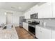 Well-lit kitchen with white cabinets, stainless steel appliances, and granite countertops at 4779 Mock Orange Sw St, Atlanta, GA 30331