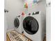 Functional laundry area featuring modern, front-load washer and dryer units at 4779 Mock Orange Sw St, Atlanta, GA 30331