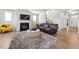 Spacious living room with a fireplace, a fluffy rug, and stairs leading up to the next level at 4779 Mock Orange Sw St, Atlanta, GA 30331