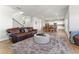 Open-concept living room flowing into the dining area and kitchen, with hardwood floors and modern decor at 4779 Mock Orange Sw St, Atlanta, GA 30331
