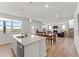 Open floor plan featuring a kitchen island, dining area, and cozy living room with a fireplace at 4779 Mock Orange Sw St, Atlanta, GA 30331