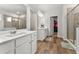 Bright bathroom featuring double sinks, walk-in shower, and access to walk-in closet at 4779 Mock Orange Sw St, Atlanta, GA 30331
