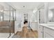 Well-lit bathroom with a glass-enclosed shower, separate vanities, and wood-style flooring at 4779 Mock Orange Sw St, Atlanta, GA 30331