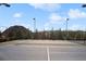 Well-maintained tennis court with lighting and fencing, providing a great space for recreational activities at 4779 Mock Orange Sw St, Atlanta, GA 30331