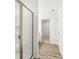Bright bathroom featuring wood-look floors and a glass-enclosed shower with white tile and shelves at 1115 Lockhart Way, Douglasville, GA 30135