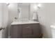 Bathroom vanity with marble countertop, gray cabinets, and bronze hardware at 1380 Tennis Court Pl, Roswell, GA 30075