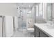 Bathroom features a glass shower, white marble walls, gray vanity, and white countertop at 1380 Tennis Court Pl, Roswell, GA 30075