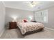 Neutral bedroom with a ceiling fan, carpeted floors, and a large window for natural light at 1380 Tennis Court Pl, Roswell, GA 30075
