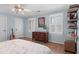 Charming bedroom with hardwood floors, a ceiling fan, and plenty of natural light from the windows at 1380 Tennis Court Pl, Roswell, GA 30075