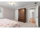 Bright bedroom with an armoire, carpeted floors, and an en suite bathroom at 1380 Tennis Court Pl, Roswell, GA 30075