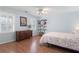 Bright bedroom features a hardwood floor, natural light, and a light blue painted wall at 1380 Tennis Court Pl, Roswell, GA 30075
