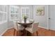 Cozy breakfast nook area with round wooden table, four chairs, and natural lighting at 1380 Tennis Court Pl, Roswell, GA 30075
