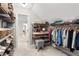 Walk-in closet featuring custom shelving, a vanity area, and organized clothing racks at 1380 Tennis Court Pl, Roswell, GA 30075