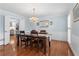 Formal dining room with hardwood floors, chandelier, and ample natural light for elegant gatherings at 1380 Tennis Court Pl, Roswell, GA 30075