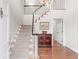 Inviting foyer with hardwood floors, elegant staircase, and classic decor for a grand entrance at 1380 Tennis Court Pl, Roswell, GA 30075