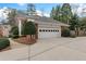 Attached two-car garage with automatic door offers convenient parking and storage at 1380 Tennis Court Pl, Roswell, GA 30075