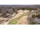 An aerial view showcases a golf course, residential properties, and lush greenery within the community at 1380 Tennis Court Pl, Roswell, GA 30075