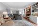 Spacious living room with brick fireplace, built-in shelving, and plush seating at 1380 Tennis Court Pl, Roswell, GA 30075