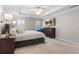 Spacious bedroom featuring a tray ceiling, neutral walls, and an en suite bathroom at 1380 Tennis Court Pl, Roswell, GA 30075